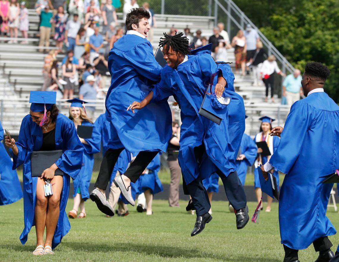 Cody Britt, left, and Chris Moore celebrate after Wake Forest High School’s Class of 2021 graduation ceremonies at the Heritage High School football stadium in Wake Forest, N.C., Wednesday, June 9, 2021. During the pandemic, Wake County high schools held graduations on campus instead of at the Raleigh Convention Center.