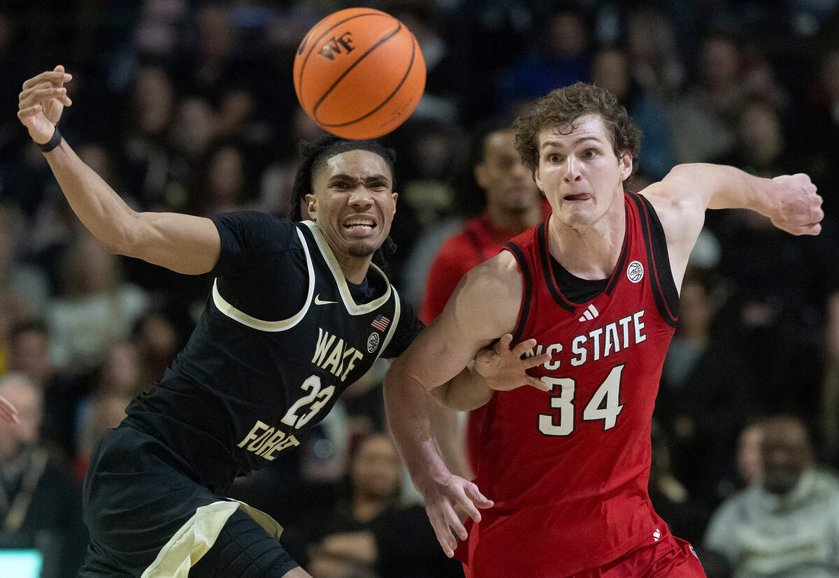 Wake Forest’s Hunter Sallis and N.C. State’s Ben Middlebrooks sprint after a loose ball during the second half of the Wolfpack’s 77-59 loss on Saturday, Jan. 4, 2025, at Lawrence Joel Veterans Memorial Coliseum in Winston-Salem, N.C.
