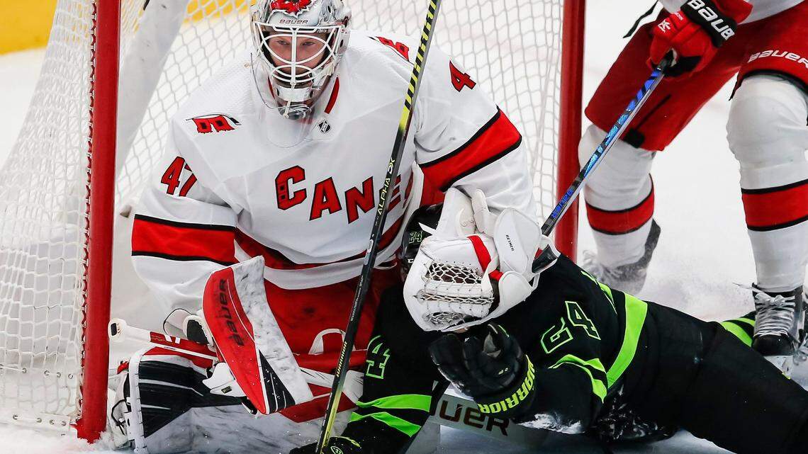 Dallas Stars forward Roope Hintz (24) slides into Carolina Hurricanes goaltender James Reimer (47) during the second period of an NHL hockey game, Monday, April 26, 2021, in Dallas. (AP Photo/Brandon Wade)