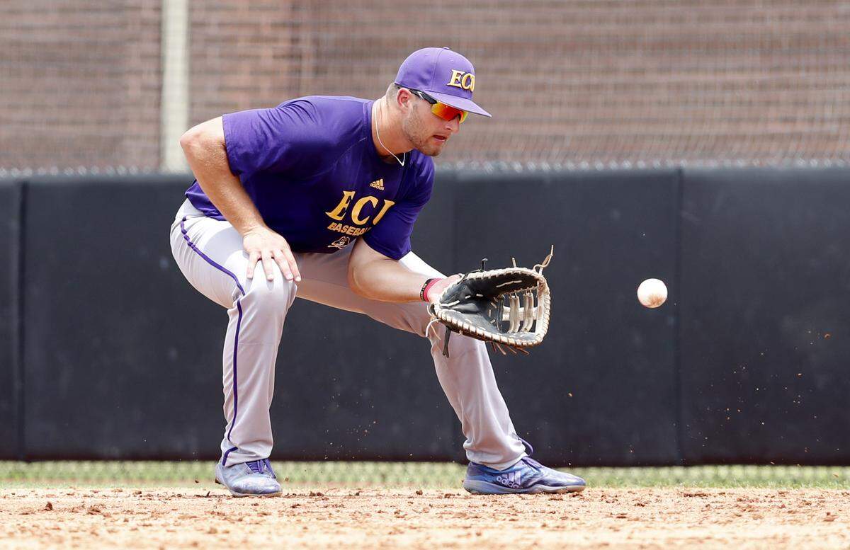 ECU’s Spencer Brickhouse (42) fields a ground ball during East Carolina’s practice at Clark-LeClair Stadium in Greenville, N.C., Tuesday, May 28, 2019.