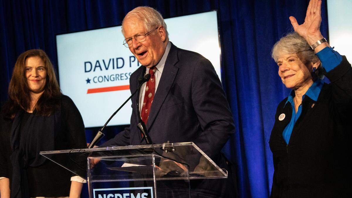 U.S. Rep. David Price (D-NC District 4) is flanked by his daughter Karen Price, left, and wife, Lisa Price, as he thanks supporters during an election night event Tuesday, Nov. 6, 2018 at the NC Democratic Party Headquarters in Raleigh.