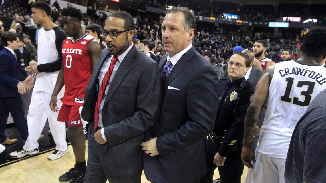 N.C. State assistant coach Orlando Early, left, and coach Mark Gottfried walk off the court after Wake Forest's 77-74 victory over the Wolfpack at Lawrence Joel Coliseum in Winston-Salem, N.C., Sunday, Jan. 10, 2016.