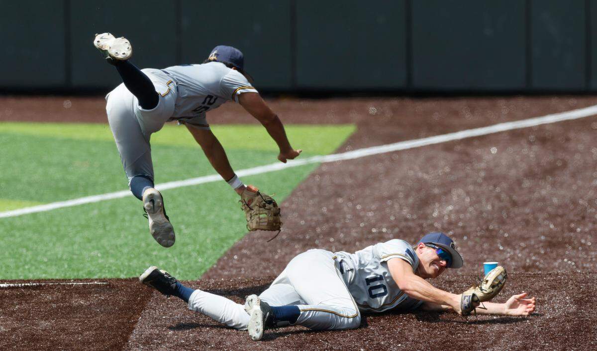 Murray State’s Brayden Buckner (25) dives over Dustin Mercer (10) after Mercer made a diving catch of a foul ball during Duke’s 7-4 victory over Murray St. in the first game of Durham Super Regional at Jack Coombs Field in Durham, N.C., Sat. June 7, 2025.