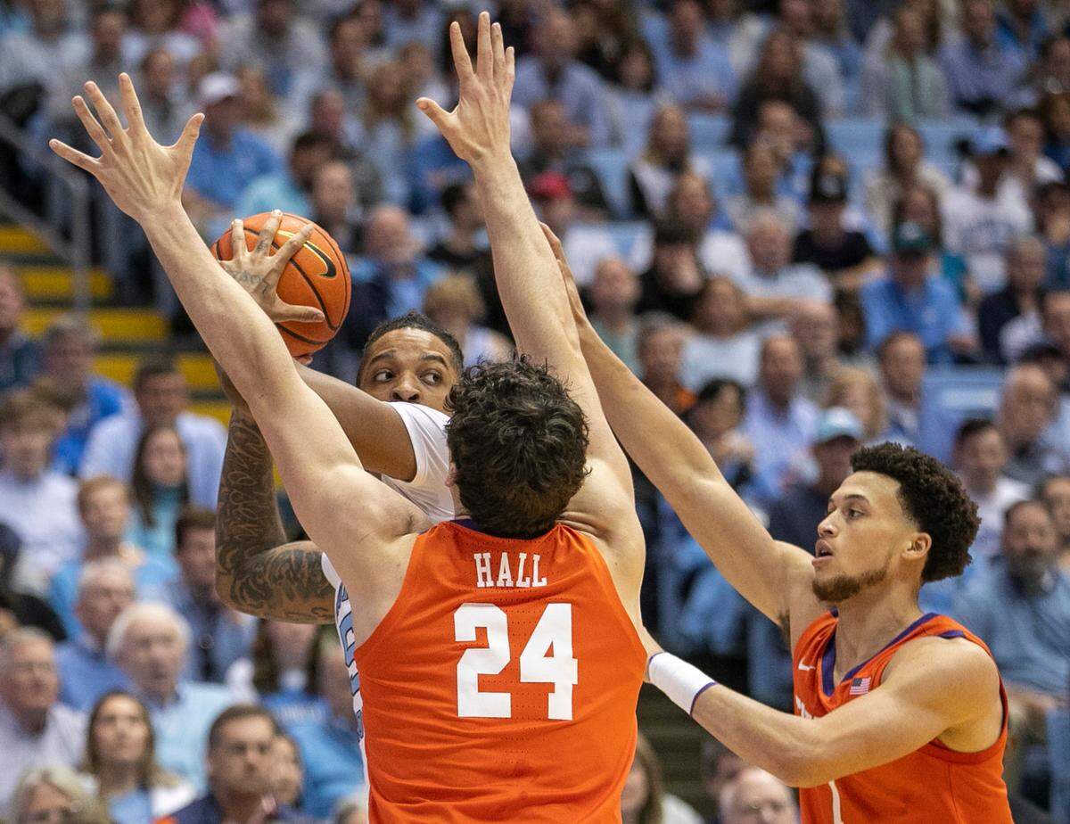 Clemson’s P.J. Hall (24) and Chase Hunter (1) trap North Carolina’s Armando Bacot (5) in the first half on Saturday, February 11, 2023 at the Smith Center in Chapel Hill, N.C.
