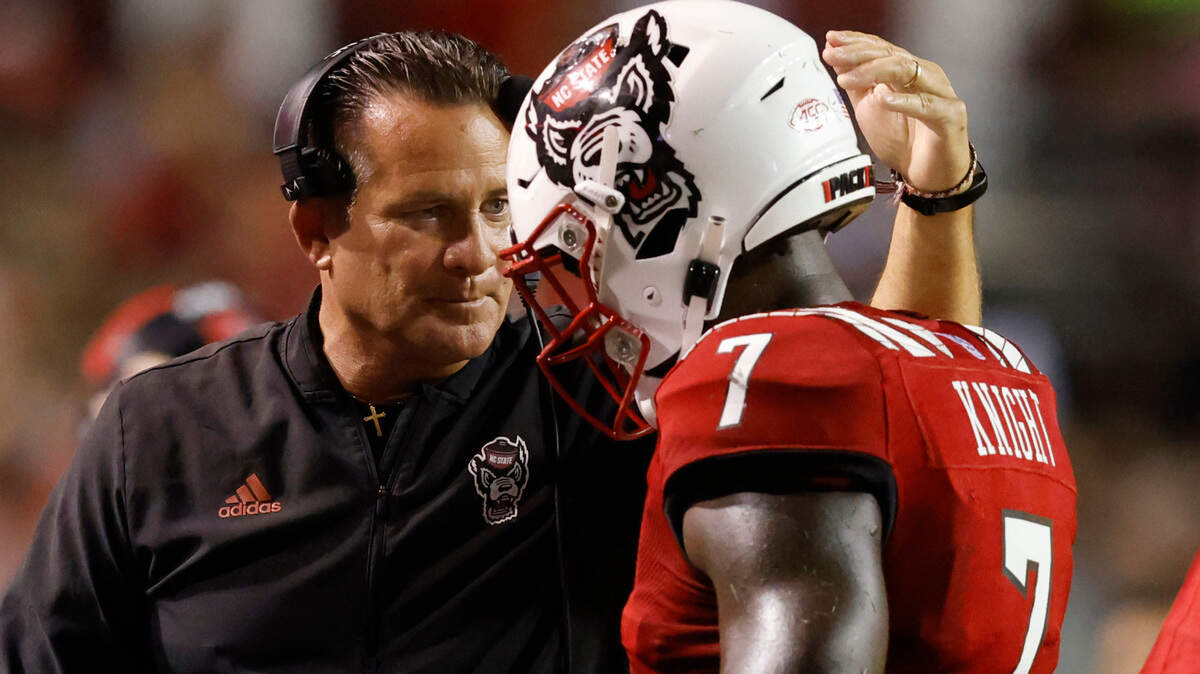 N.C. State offensive coordinator Tim Beck congratulates running back Zonovan ‘Bam’ Knight (7) after the Wolfpack scored during the first half of N.C. State’s game against Furman at Carter-Finley Stadium in Raleigh, N.C., Saturday, Sept 18, 2021.
