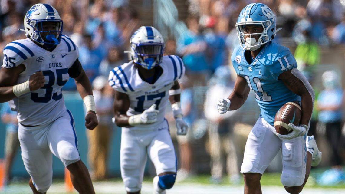 North Carolina’s Josh Downs (11) scores on a 63-yard pass reception from quarterback Sam Howell ahead of Duke’s Dorian Mausi (35) and Da’Quan Johnson (17) and in the fourth quarter on Saturday, October 2, 2021 at Kenan Stadium in Chapel Hill, N.C.