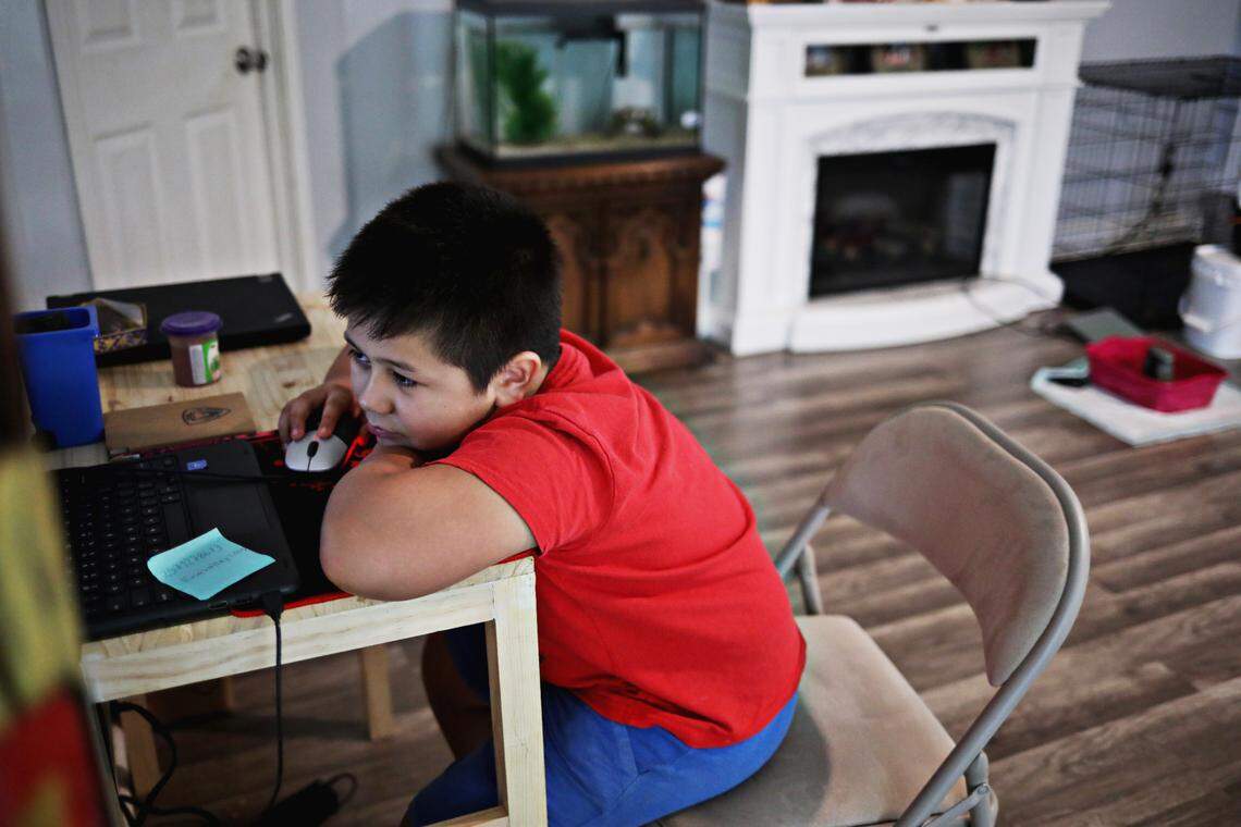 Gael Obregon, 8, whose home language is Spanish, looks over homework for his online school classes at his Durham home on Oct. 28, 2020. Obergon and his mother, Patricia, struggle with his school’s English-only online learning system.