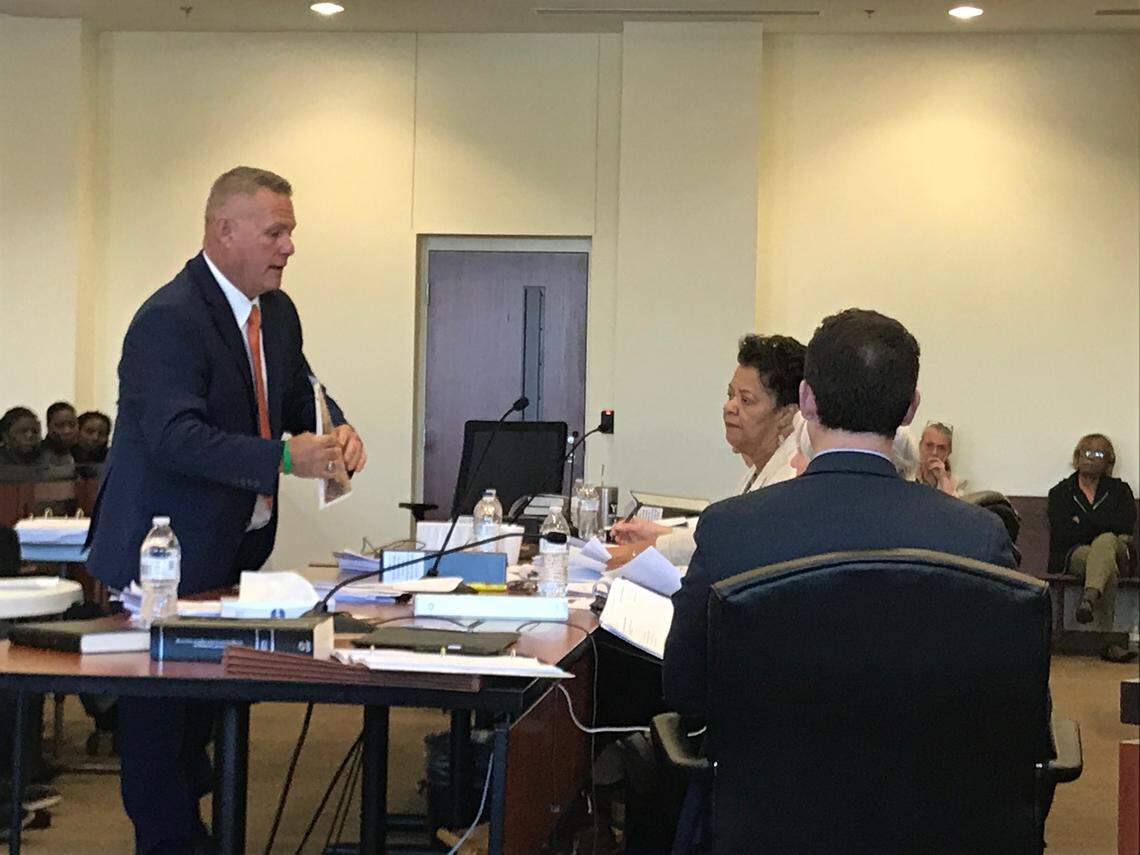 Jody Greene, the Republican candidate for Columbus County sheriff, shows the county board of elections an aerial photo of his Cerro Gordo property on April 4.