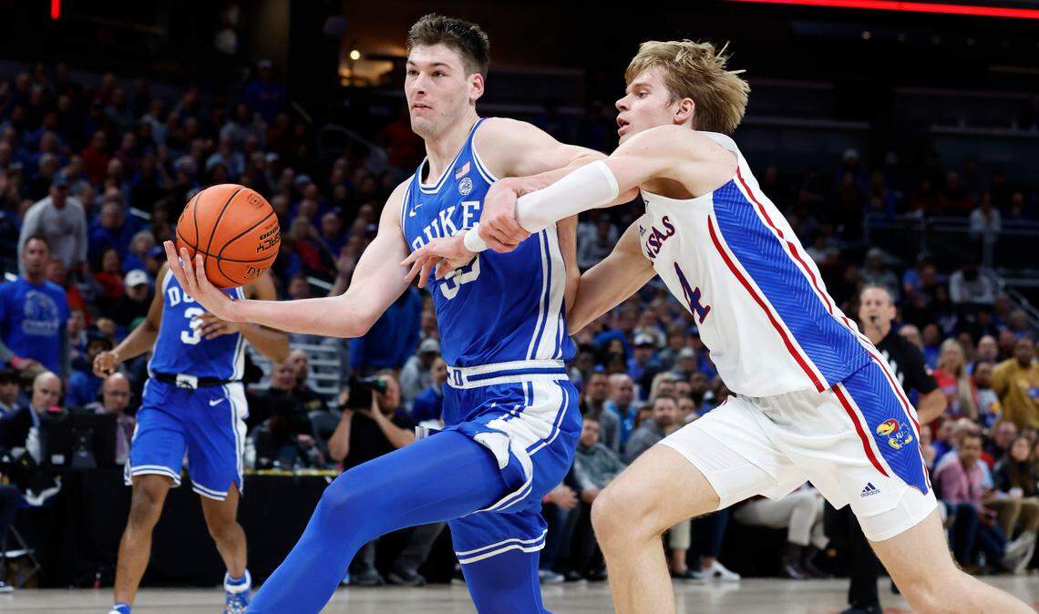 Duke’s Kyle Filipowski (30) drives by Kansas’ Gradey Dick (4) during the second half of Kansas’ 69-64 victory over Duke in the State Farm Champions Classic in Indianapolis, Ind. Tuesday, Nov. 15, 2022.