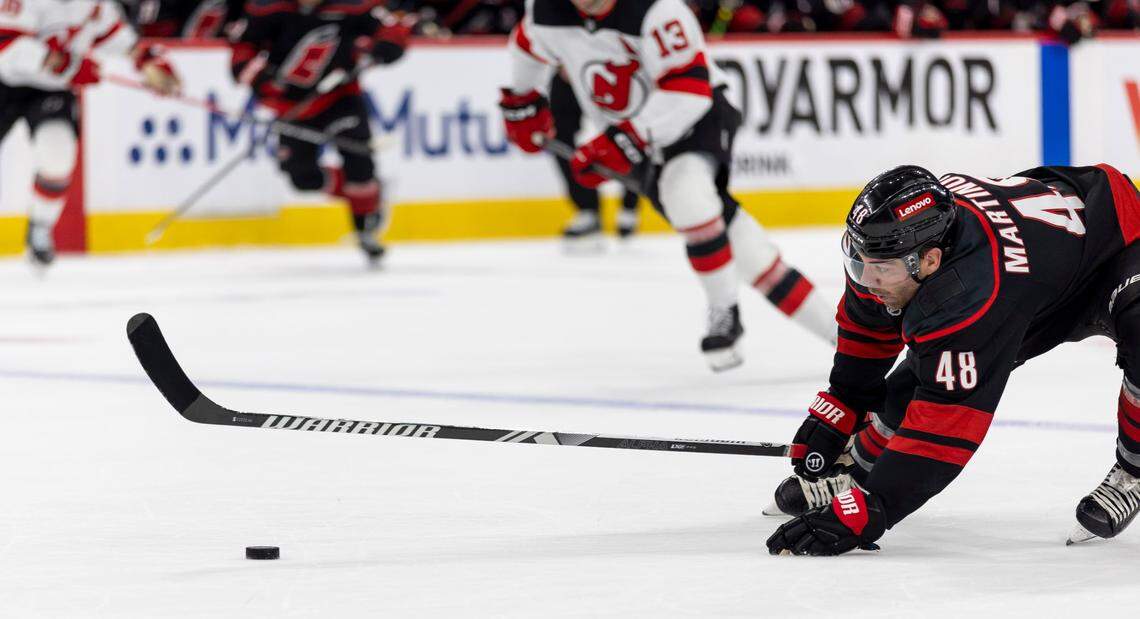 Carolina Hurricanes left wing Jordan Martinook (48) tries to gain control of the puck in the first period against the New Jersey Devils during game two of their Stanley Cup playoff series on Tuesday, April 22, 2025 at Lenovo Center in Raleigh, N.C.