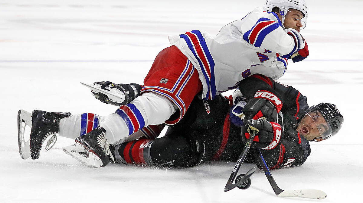 Carolina Hurricanes’ Jordan Martinook (48) collides with New York Rangers’ Tony DeAngelo (77) during the second period of an NHL hockey game, Sunday, Oct. 7, 2018, in Raleigh, N.C. 