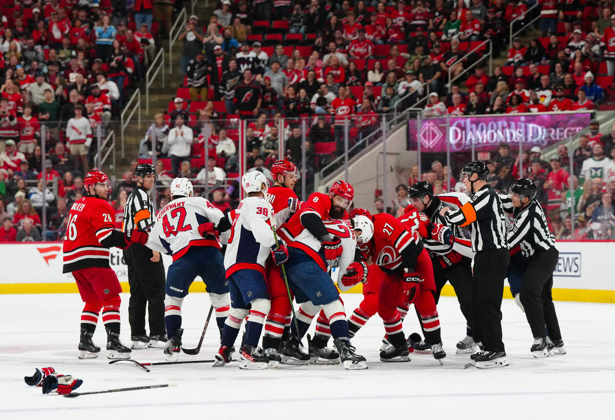 Carolina Hurricanes center Mark Jankowski (77) center Tyson Jost (27), defenseman Brent Burns (8), center Jesperi Kotkaniemi (82) and defenseman Sean Walker (26) battle Washington Capitals defenseman Martin Fehérváry (42), defenseman Rasmus Sandin (38) and right wing Brandon Duhaime (22) during the third period at Lenovo Center.