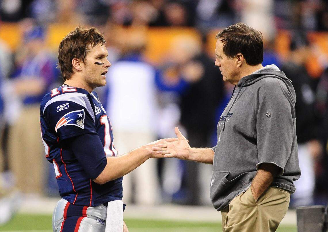 Feb 5, 2012; Indianapolis, IN, USA; New England Patriots quarterback Tom Brady (12) shakes hands with head coach Bill Belichick before Super Bowl XLVI against the New York Giants at Lucas Oil Stadium.  Mandatory Credit: Mark J. Rebilas-USA TODAY Sports