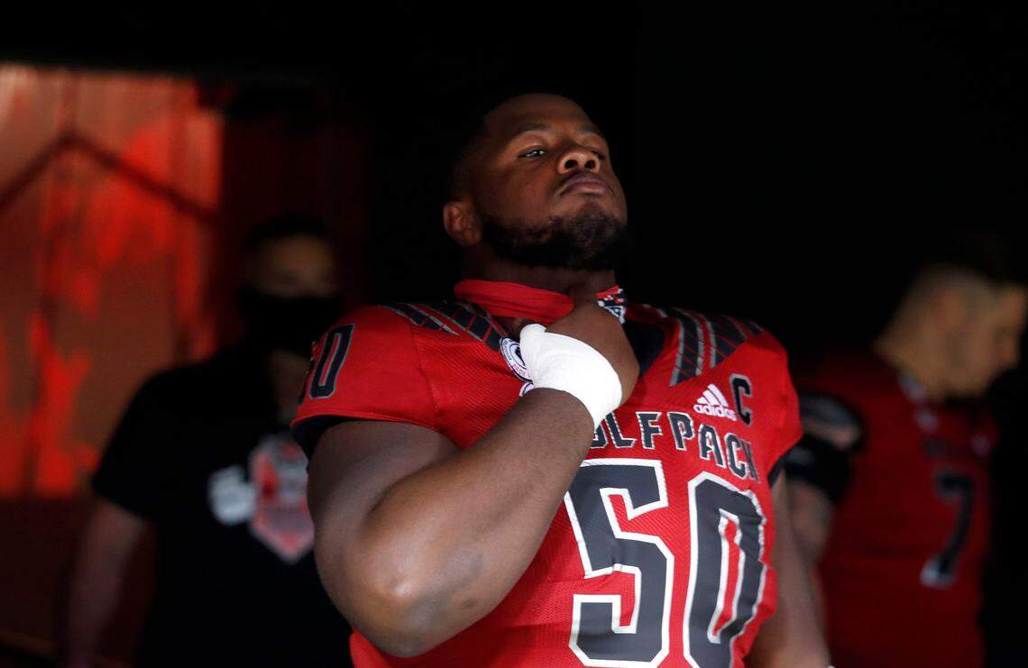 N.C. State center Grant Gibson (50) prepares to head onto the field to warmup before N.C. State’s game against Florida State at Carter-Finley Stadium in Raleigh, N.C., Saturday, Nov. 14, 2020.