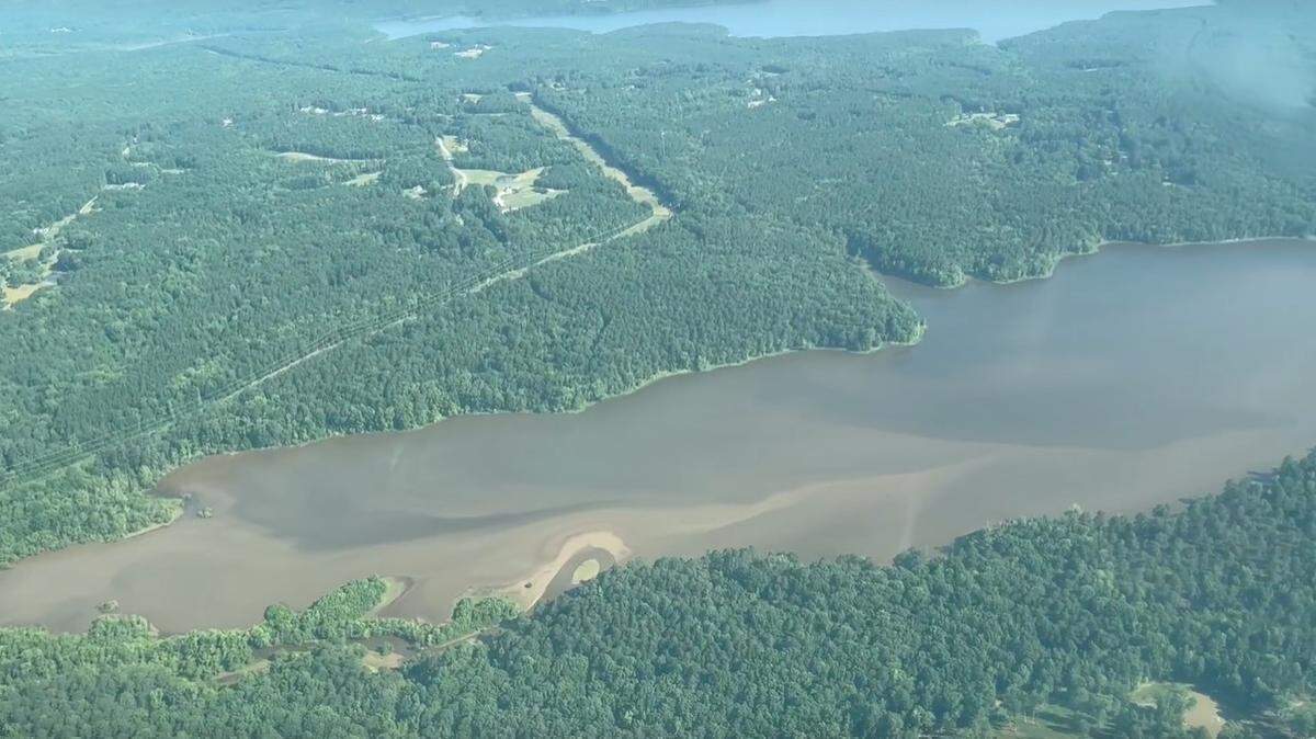 Sediment from Lick Creek is making its way downstream into a branch Falls Lake, as shown in this photo from an aerial flight taken in June 2023. Sound Rivers is suing Clayton Properties Group, alleging sediment from its Sweetbrier development is impacting Martin Branch and then Lick Creek before reaching Falls Lake.