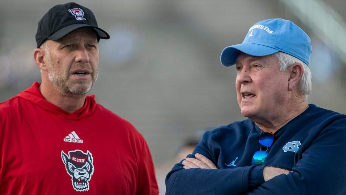 North Carolina coach Mack Brown talks with N.C. State coach Dave Doeren prior to their game on Friday, November 25, 2022 at Kenan Stadium in Chapel Hill, N.C.
