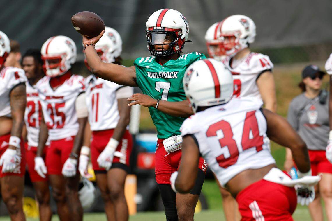 N.C. State quarterback MJ Morris (7) passes to Delbert Mimms III (34) during the Wolfpack’s first fall practice in Raleigh, N.C., Wednesday, August 2, 2023.