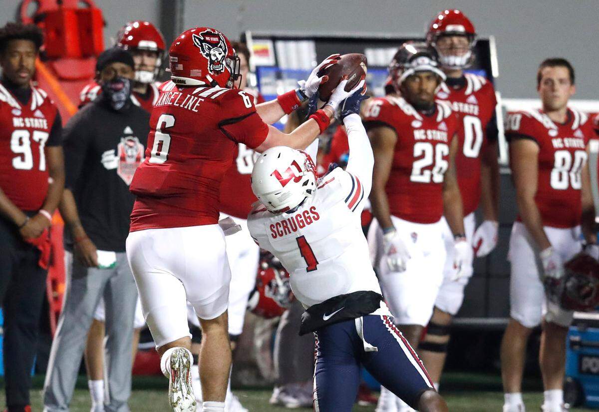 N.C. State tight end Cary Angeline (6) pulls in the reception from Liberty safety Javon Scruggs (1) during the first half of N.C. State’s game against Liberty at Carter-Finley Stadium in Raleigh, N.C., Saturday, Nov. 21, 2020.