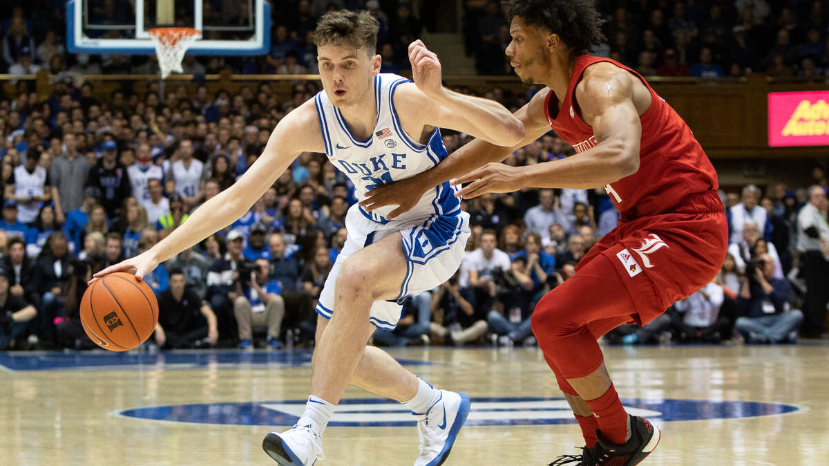 Duke’s Matthew Hurt (21) drives against Louisville’s Dwayne Sutton, right, during an NCAA college basketball game in Durham, N.C., Saturday, Jan. 18, 2020.