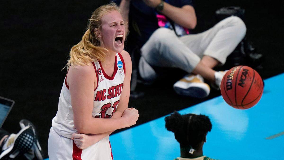 North Carolina State center Elissa Cunane celebrates in front of South Florida forward Bethy Mununga (20) after making a basket during the second half of a college basketball game in the second round of the women’s NCAA tournament at the Alamodome in San Antonio, Tuesday, March 23, 2021. 