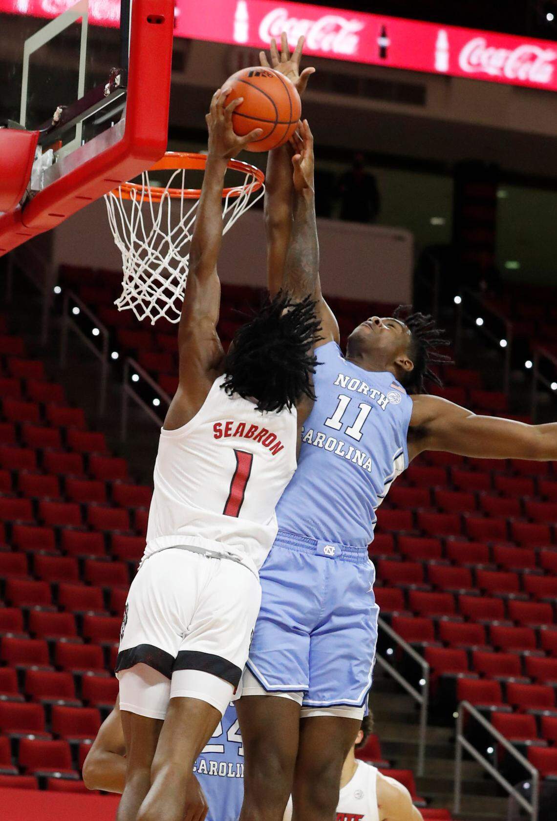 North Carolina’s Day’Ron Sharpe (11) blocks the shot by N.C. State’s Dereon Seabron (1) during the first half of N.C. State’s game against UNC at PNC Arena in Raleigh, N.C., Tuesday, December 22, 2020.