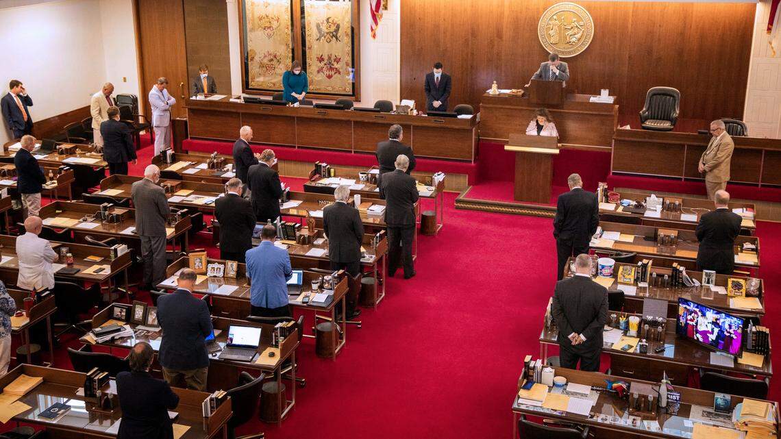 NC House members stand during an opening prayer on May 2. Lawmakers recently allocated $3.5 million in federal COVID-19 relief funds for a pilot project run by a new domestic violence nonprofit. Other domestic violence groups said the money would have been better spent on shelters and emergency housing.