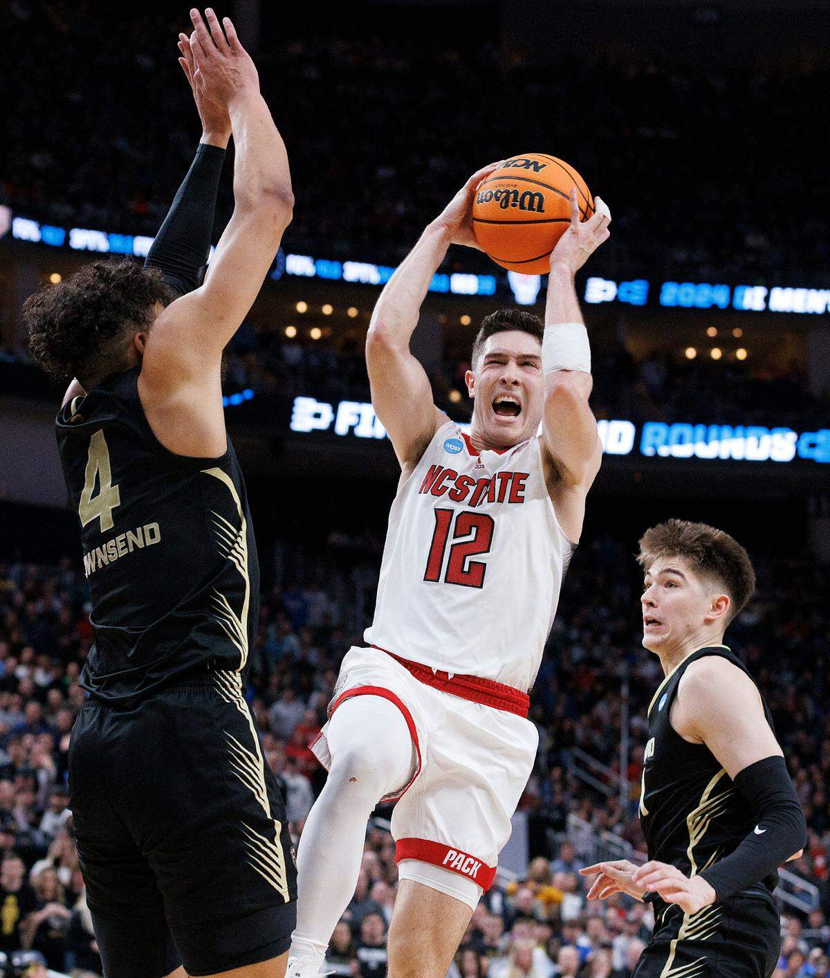 N.C. State’s Michael O’Connell drives against Oakland’s Trey Townsend during the second half of the Wolfpack’s 79-73 overtime win in the second round of the NCAA Tournament on Saturday, March 23, 2024, at PPG Paints Arena in Pittsburgh, Pa.