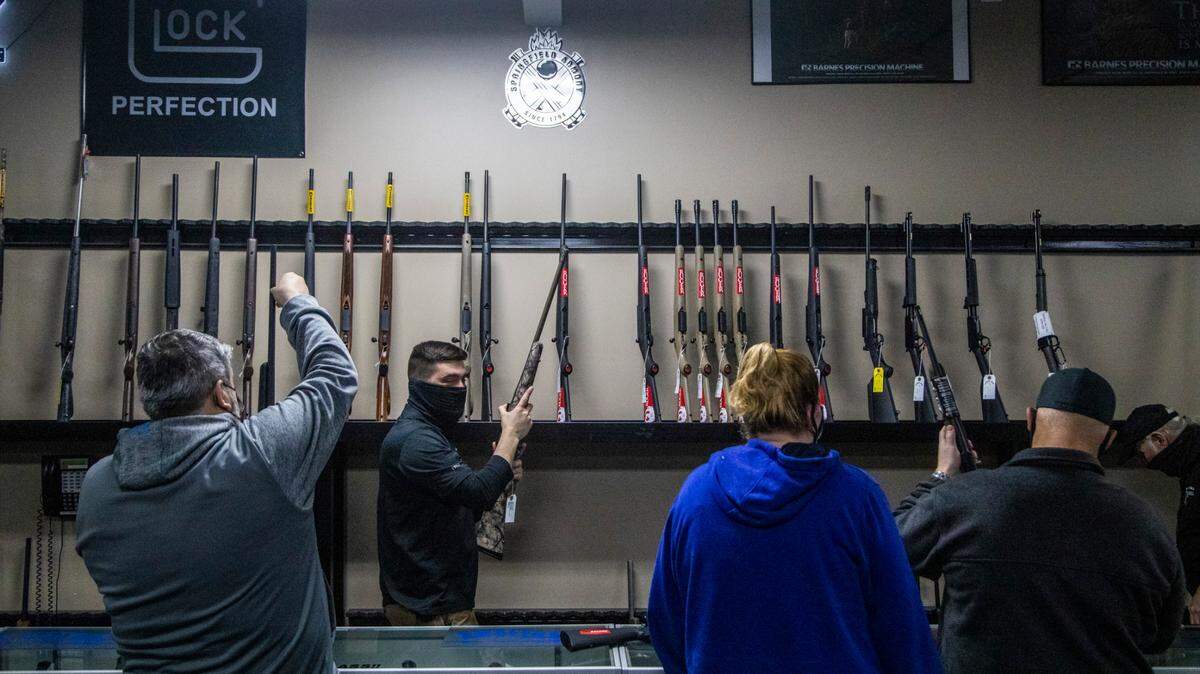 Dylan Signorell, second from left, retrieves a guns for a customer at Fuquay Gun & Gold in Fuquay-Varina Monday, Jan. 25, 2020. Gun sales have soared across the Triangle in the wake of recent protests and a change in the presidential administration.