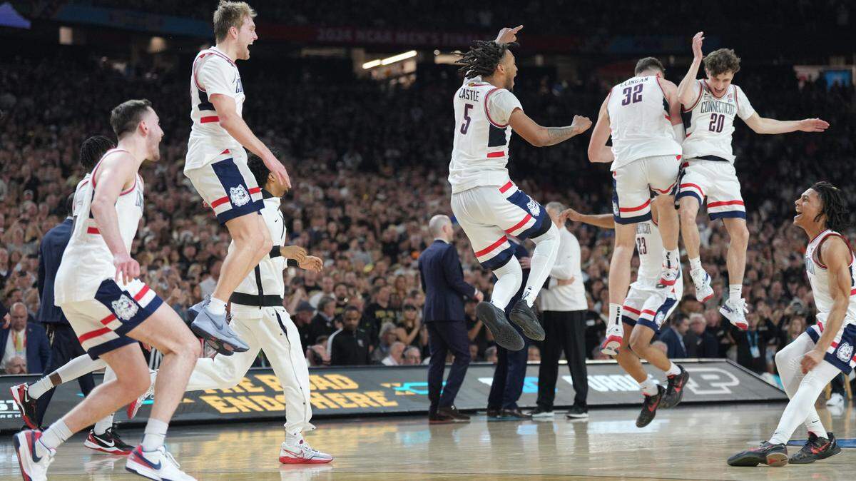 Connecticut Huskies players celebrate on the court after defeating the Purdue Boilermakers in the national championship game of the Final Four of the 2024 NCAA Tournament at State Farm Stadium.