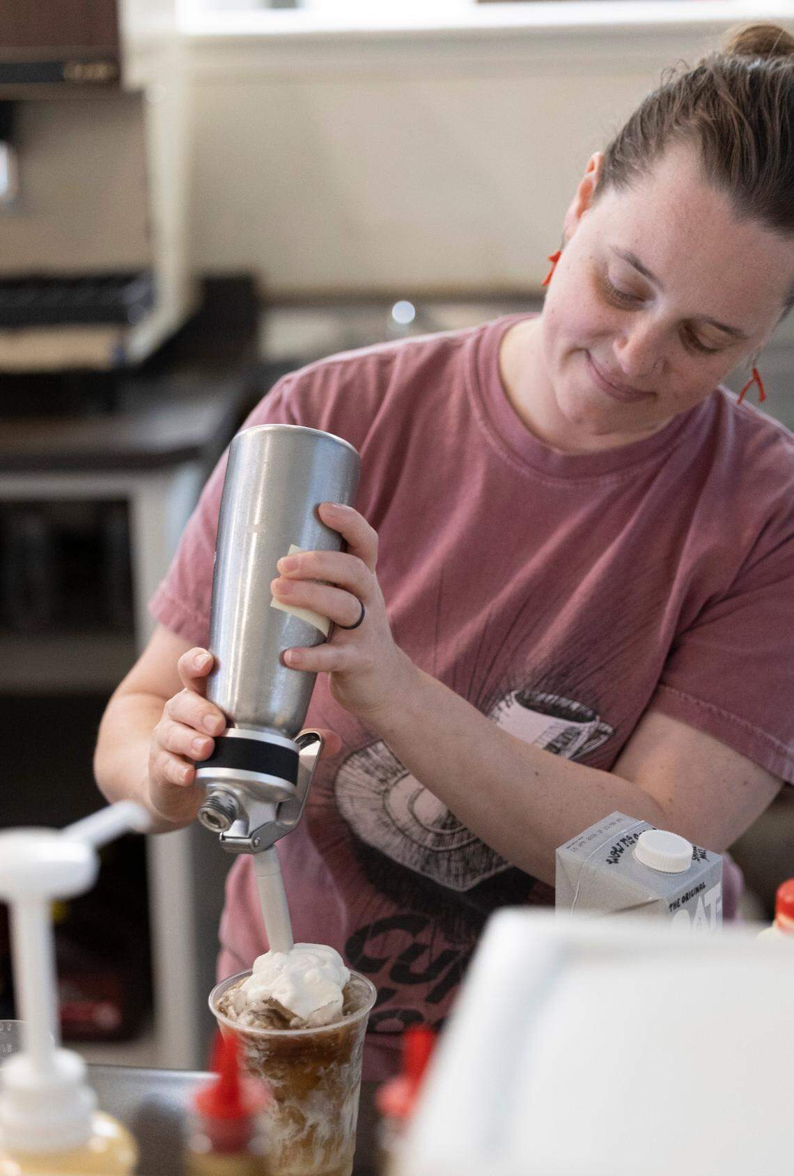 Co-owner Andi Macko prepares a cold coffee drink during the reopening of Cup-A-Joe’s Mission Valley location in Raleigh on Tuesday, June 24, 2025. The café closed in 2021 during the pandemic. Its soft-opening pop-up runs through Friday, June 27, from 8 a.m. to 1 p.m. The shop will close Friday afternoon and reopen Aug. 11.