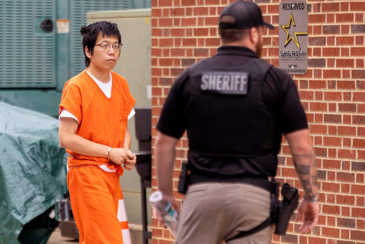 Tailei Qi is escorted into the Orange County Courthouse for his first court appearance on Tuesday, August 29, 2023 in Hillsborough, N.C. Qi, a graduate student at the University of North Carolina in Chapel Hill, N.C., faces first-degree murder charges in the shooting of a faculty member