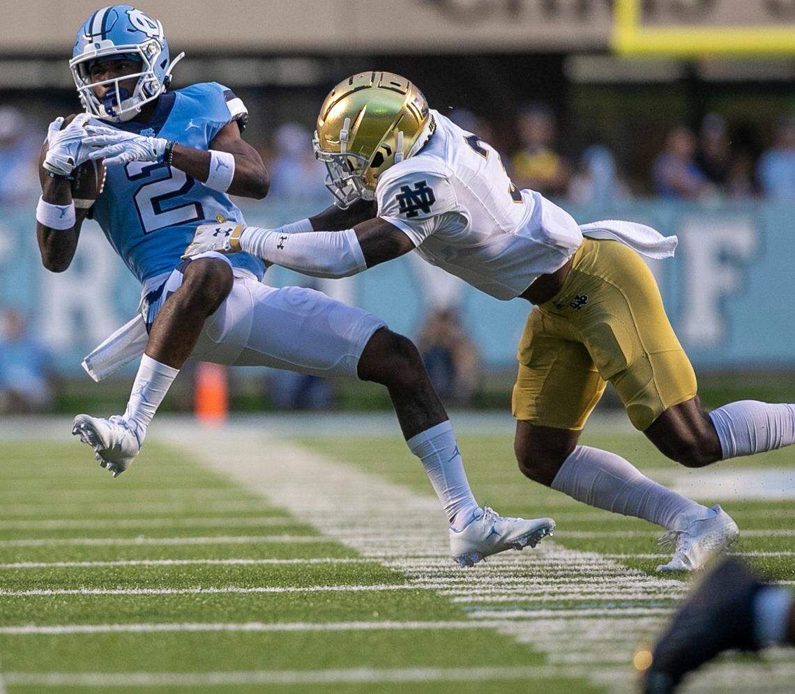 North Carolina’s Gavin Blackwell (2) pulls in a pass from quarterback Drake Maye for an eight-yard gain in the fourth quarter against Notre Dame’s Houston Griffith (3) on Saturday, September 24, 2022 at Kenan Stadium in Chapel Hill, N.C.