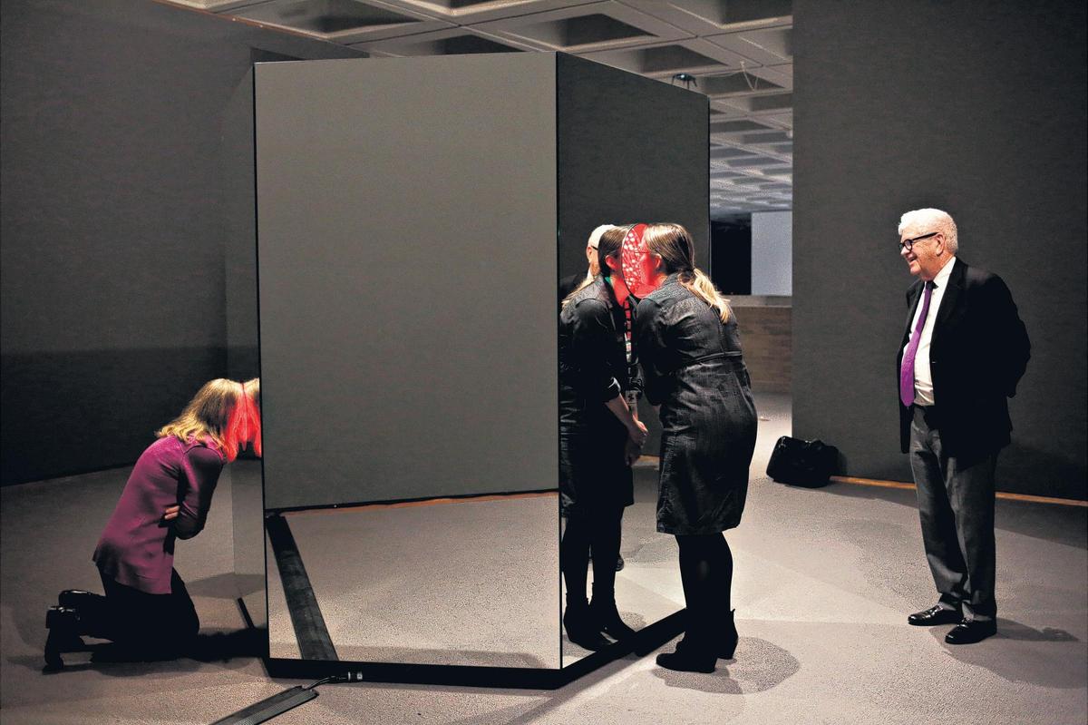 From left, Linda Dougherty, NCMA chief curator, Kat Harding, NCMA public relations manager, and NCMA director Larry Wheeler look over the North Carolina Museum of Art's newest acquisition, Yayoi Kusama's "Light of Life" on Monday, March 26, 2018. From the outside, the piece looks like a mirrored hexagonal box but stick your head inside one of its three portholes, and you'll see yourself transported into an enclosed "infinity room" of changing colors and patterns.