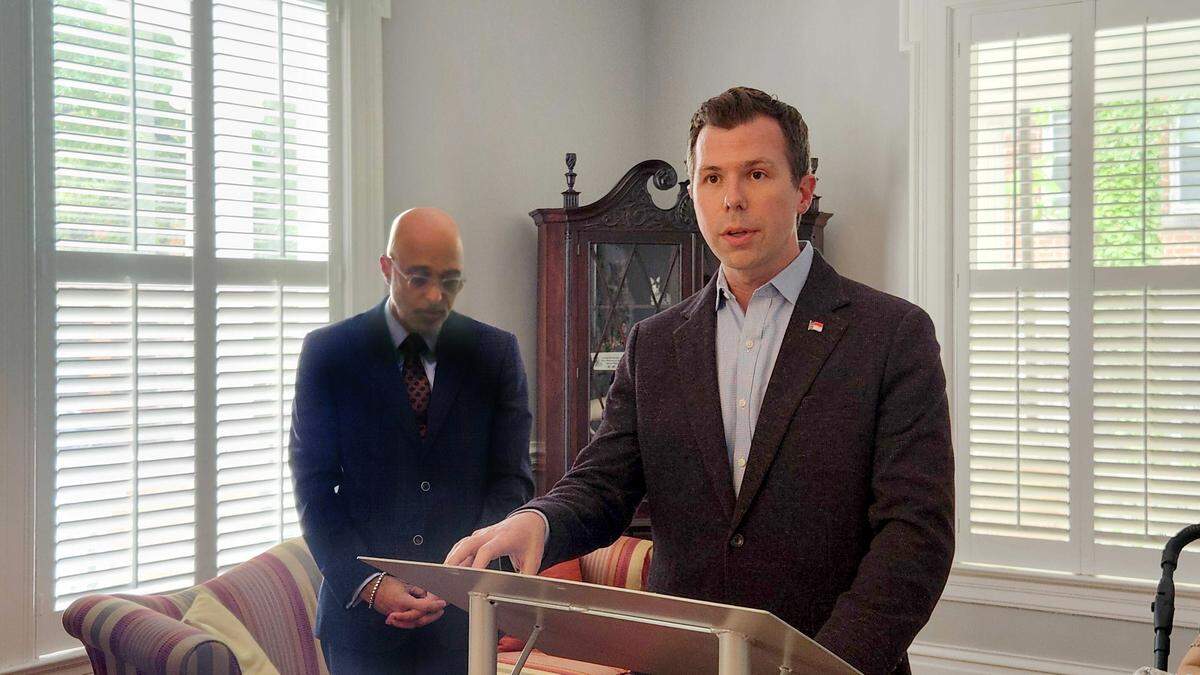N.C. Rep. Phil Rubin, at lectern, and former Rep. James Gailliard, both Democrats, talked to reporters on Tuesday, tying Republican U.S. Senate candidate Michael Whatley to former Lt. Gov. Mark Robinson.