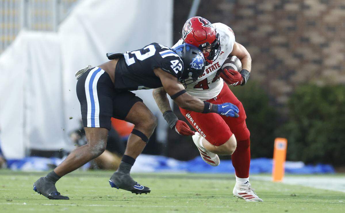 Duke linebacker Kendall Johnson (42) tackles N.C. State tight end Cody Hardy (44) during the second half of Duke’s 45-33 victory over N.C. State at Wallace Wade Stadium in Durham, N.C., Sat. Sept. 20, 2025