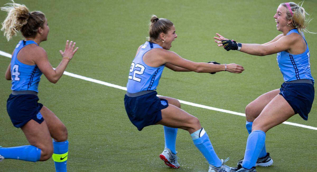 North Carolina’s Jasmina Smolenaars (22) rushes to teammate Ryleigh Heck (12) after Heck scored the game winning goal in a sudden death shootout on Northwestern goalie Annabel Skubisz to clinch the NCAA Division I Field Hockey Championship on Sunday, November 19, 20223 at Karen Shelton Stadium in Chapel Hill, N.C.