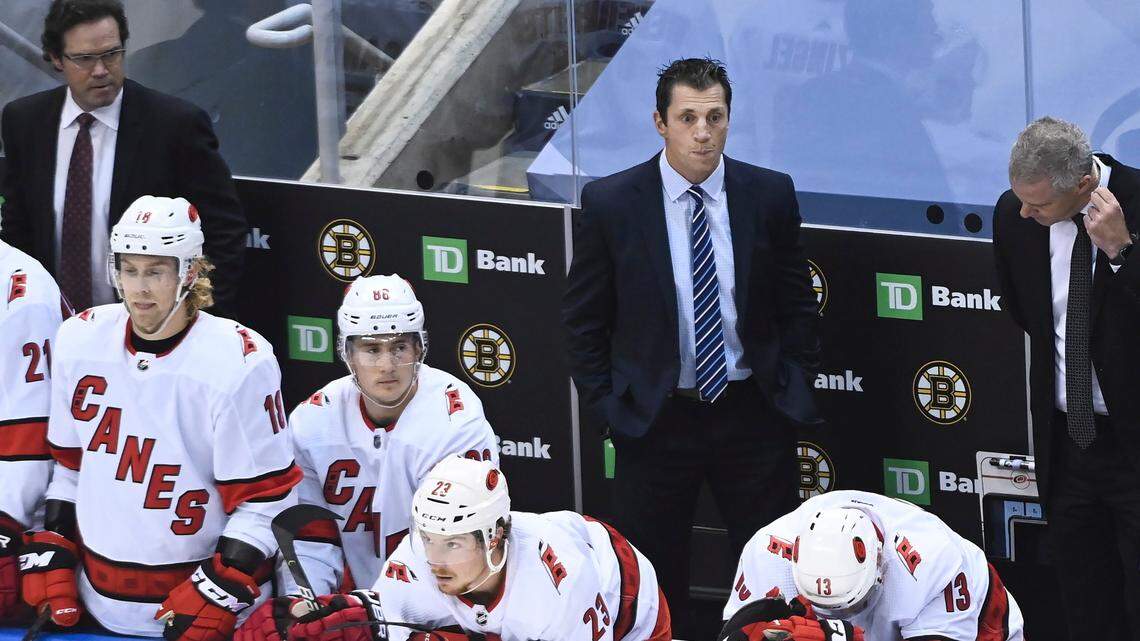 Carolina Hurricanes head coach Rod Brind’Amour, back center, looks on as players on the bench hang their heads after being eliminated by the Boston Bruins in an NHL Eastern Conference Stanley Cup playoff hockey game in Toronto, Ontario, on Wednesday, Aug. 19, 2020. (Nathan Denette/The Canadian Press via AP)