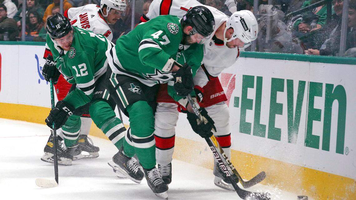 Dallas Stars right wing Alexander Radulov (47) and Carolina Hurricanes defenseman Brendan Smith (7) battle for the puck in the first period of an NHL hockey game Tuesday, Nov. 30, 2021, in Dallas. (AP Photo/Richard W. Rodriguez)