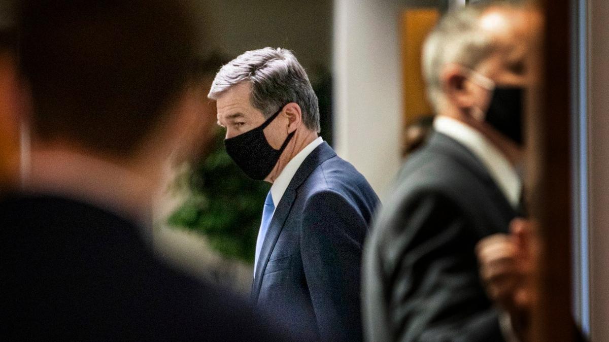 Gov. Roy Cooper leaves a briefing on North CarolinaÕs coronavirus pandemic response Tuesday, Jan. 12, 2021 at the NC Emergency Operations Center in Raleigh.