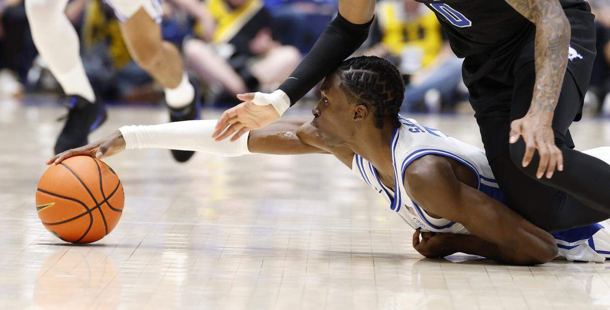 Duke’s Dame Sarr (7) dives after a loose ball in front of SMU’s Jaden Toombs (10) during the first half of Duke’s game against SMU at Cameron Indoor Stadium in Durham, N.C., Saturday, Jan. 10, 2026.