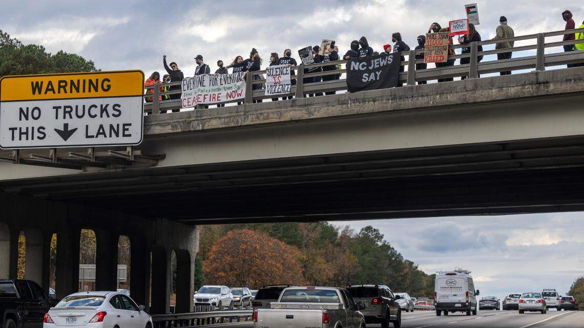 A group of demonstrators organized by Jewish Voice for Peace hold signs and banners on both sides of the North Harrison Avenue overpass over Interstate 40 in Cary Wednesday afternoon, Nov. 22, 2023. The demonstrators were calling for a cease-fire in Gaza.