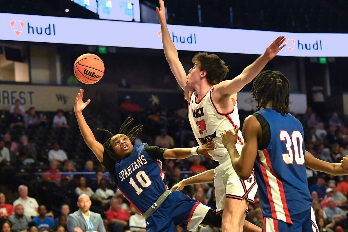 Sanderson’s Kendrick Pulley (10) launches the layup against New Hanover’s Nolan Billings (34) during the second half. The Sanderson Spartans and the New Hanover Wildcats met in the NCHSAA 4A East Regional Final in Winston-Salem, N.C. on March 12, 2025.