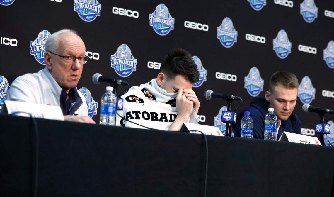 From left, Syracuse head coach Jim Boeheim and his sons, Jimmy Boeheim and Buddy Boeheim speak after Duke’s 88-79 victory over Syracuse in the quarterfinals of the ACC men’s basketball tournament at the Barclays Center in Brooklyn, N.Y., Thursday, March 10, 2022.
