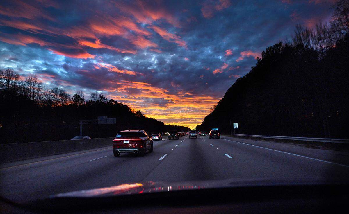 A brilliant sunset greets drivers on their evening commute heading west on I-40 in Raleigh, Monday evening, Dec. 22, 2025.