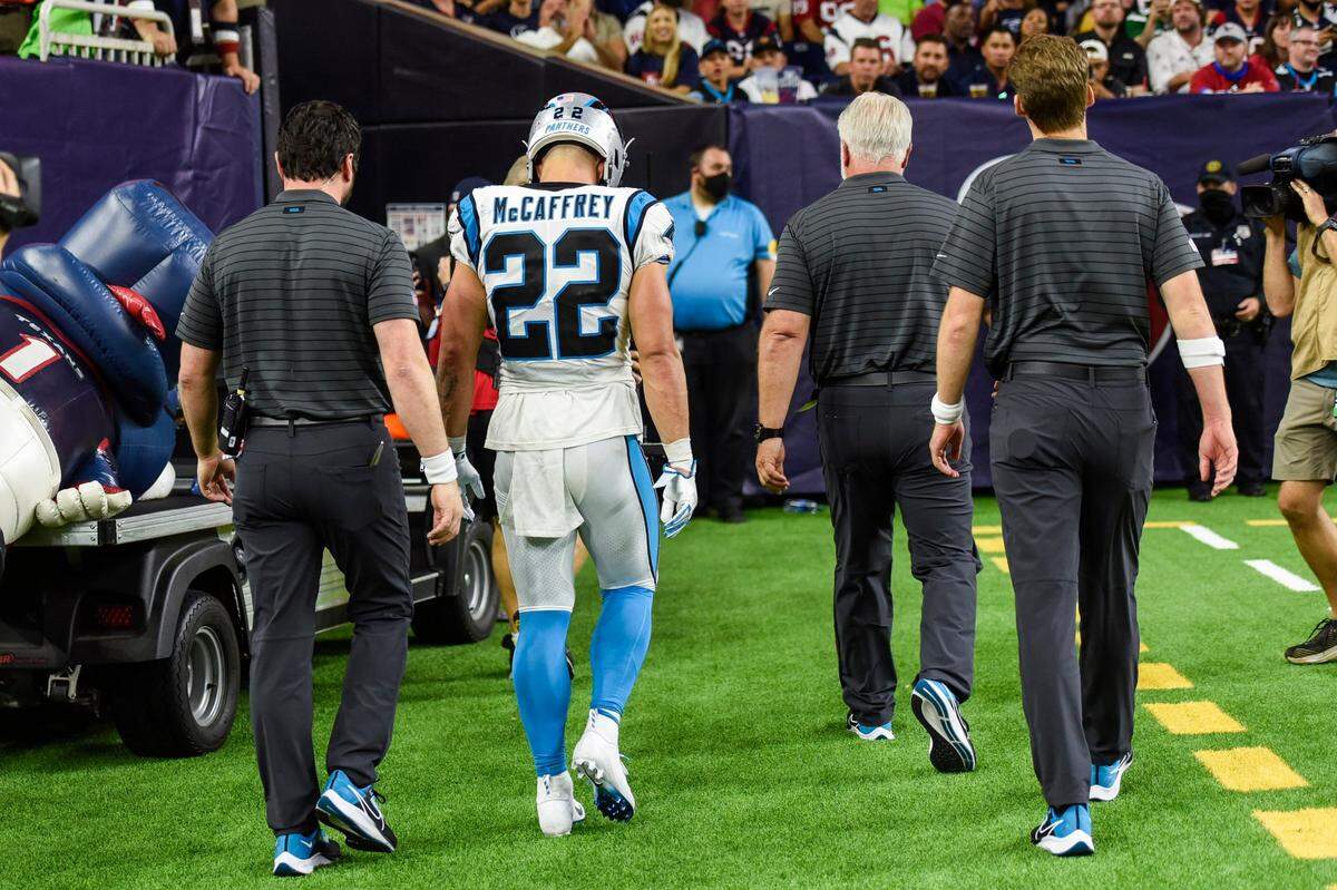 Panthers running back Christian McCaffrey, center, walks to the locker room after a hamstring injury during the game against the Texans at NRG Stadium on Sept. 23. McCaffrey said he “definitely” feels like he will return to play on Sunday against Philadelphia.