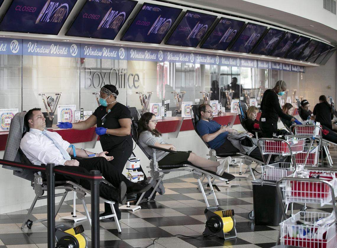 Blood donors fill the lobby of the PNC box office during an Emergency Blood drive on Thursday, March 26, 2020 at a the PNC Arena in Raleigh, N.C. The blood drive in the wake of the spread of the COVID-19 virus was sponsored by The Blood Connection, WakeMed and UNC Health.
