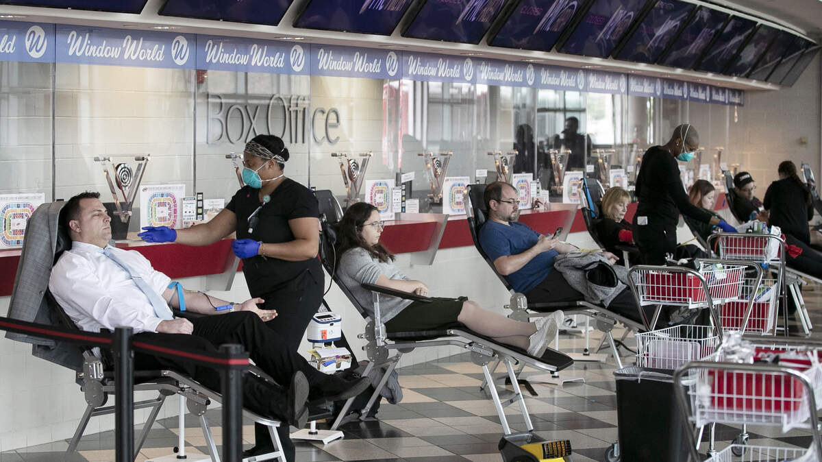 Blood donors fill the lobby of the PNC box office during an Emergency Blood drive on Thursday, March 26, 2020 at a the PNC Arena in Raleigh, N.C. The blood drive in the wake of the spread of the COVID-19 virus was sponsored by The Blood Connection, WakeMed and UNC Health.
