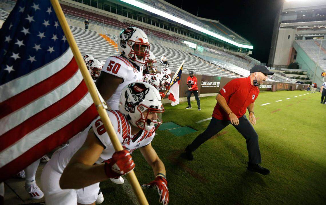 N.C. State head coach Dave Doeren leads his team onto the field before N.C. State’s game against Virginia Tech at Lane Stadium in Blacksburg, VA Saturday, Sept. 26, 2020.