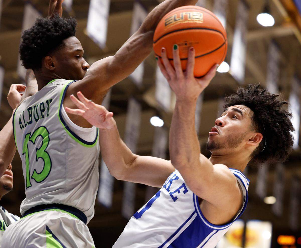 Duke’s Jared McCain (0) shoots while defended by Queens’ Deyton Albury (13) during the second half of Duke’s 106-69 victory over Queens University at Cameron Indoor Stadium in Durham, N.C., Saturday, Dec. 30, 2023.