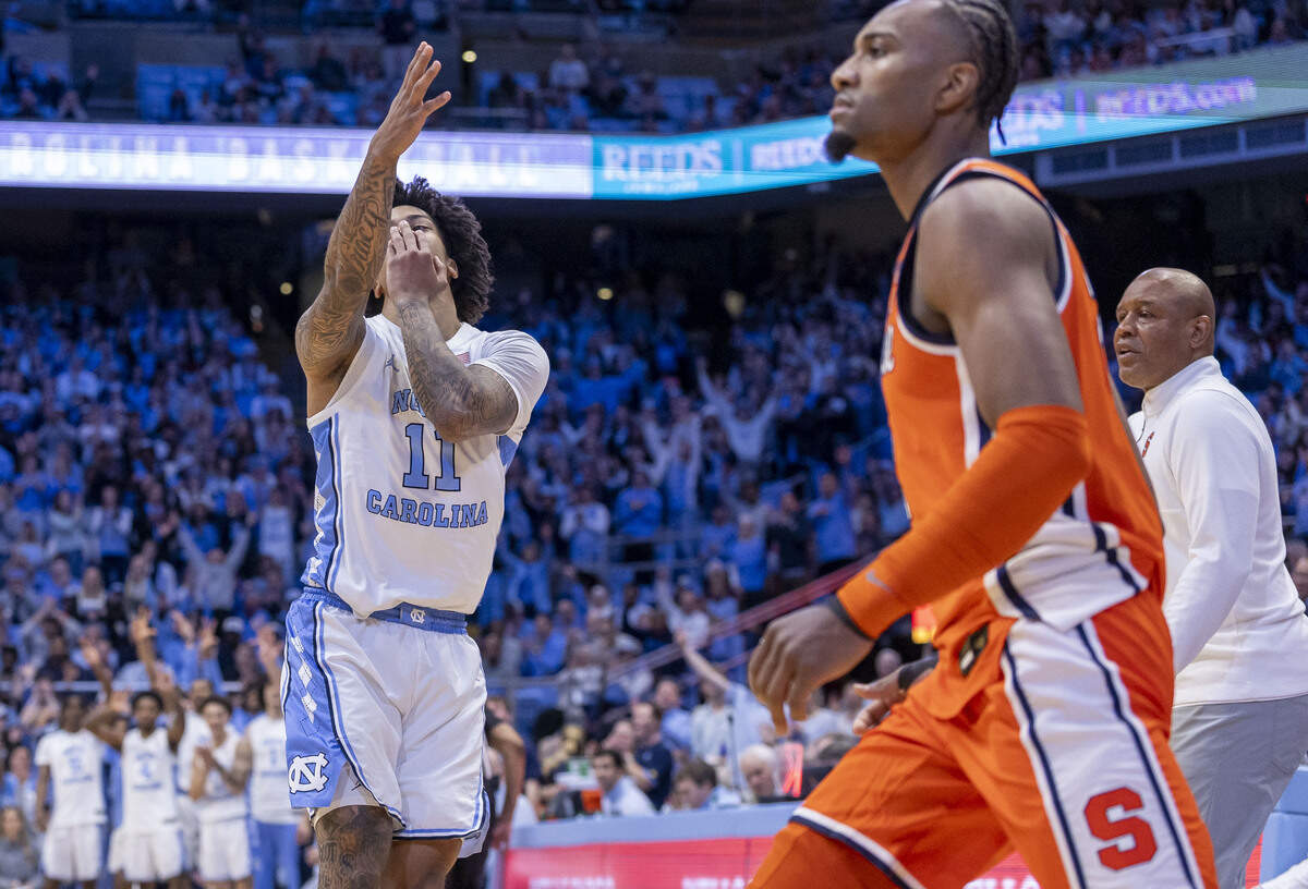North Carolina guard Jonathan Powell (11) reacts after sinking a three-point basket in front of the Syracuse bench during the first half on Monday, February 2, 2026 at the Smith Center in Chapel Hill, N.C.